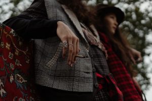 woman in black and white plaid scarf and black long sleeve shirt
